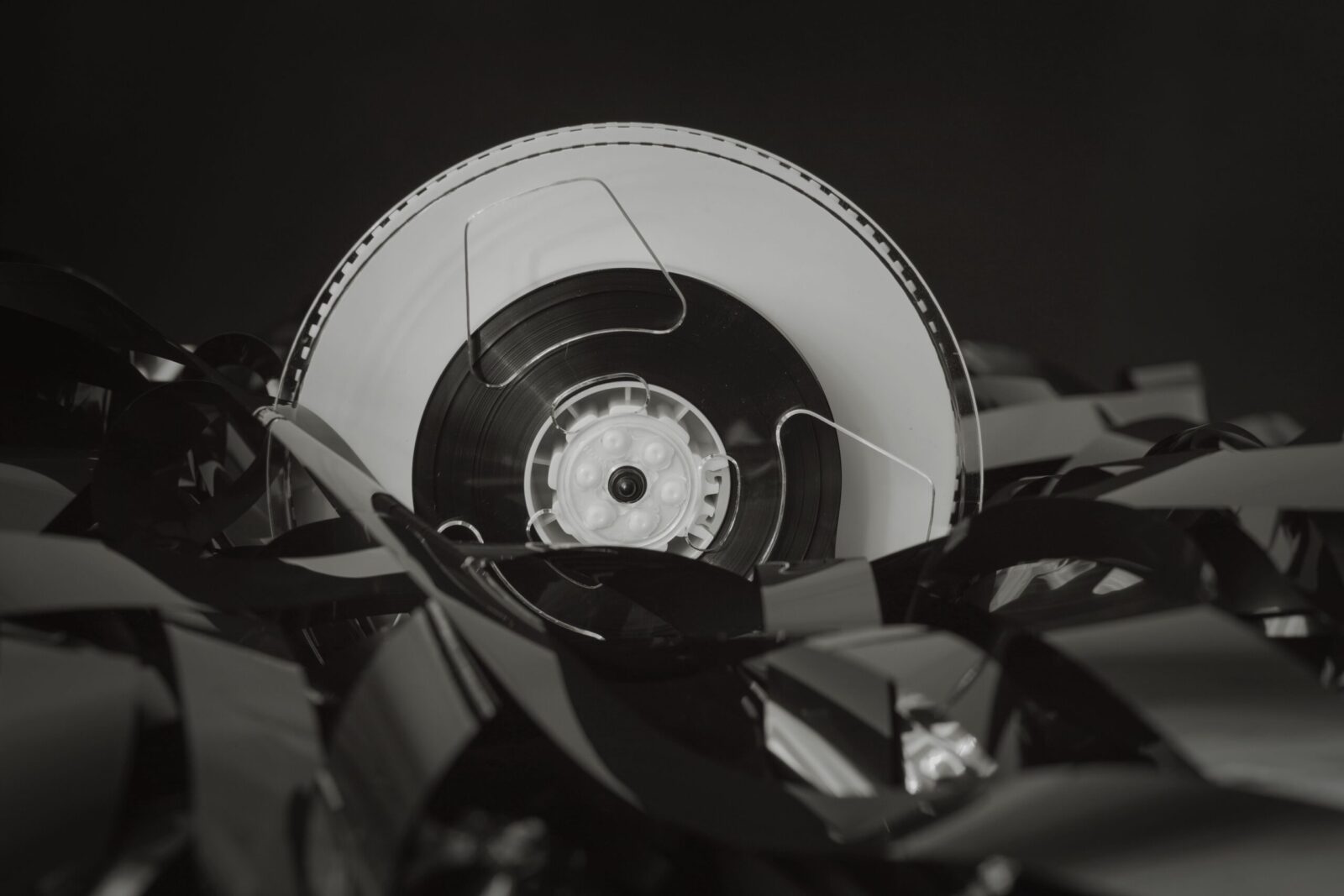 Close-up of a vintage cassette tape against a black background, showcasing retro technology.