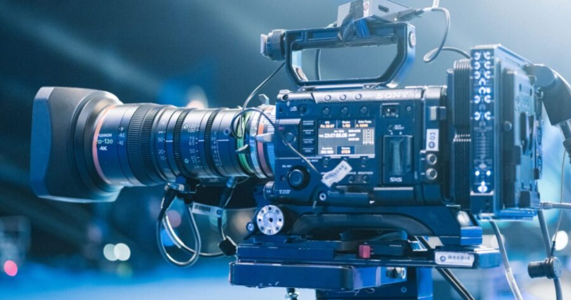 High-end professional video camera setup for filming on set with bright stage lights.